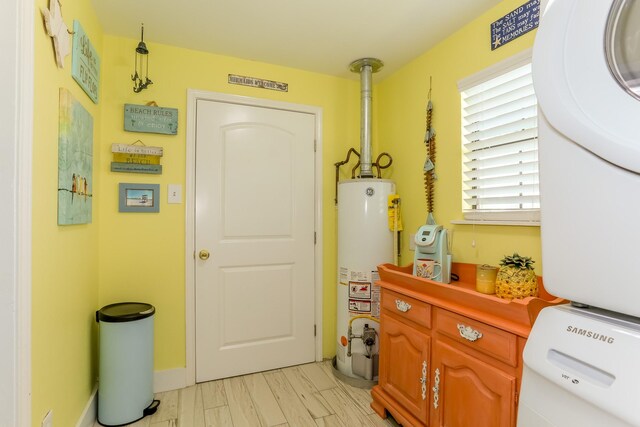 1523 22nd St, Galveston, TX 77550 - interior space featuring stacked washing machine and dryer, gas water heater, cabinet space, and baseboards