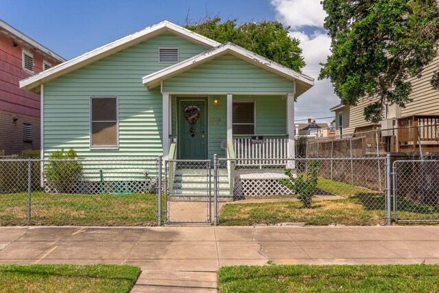 1523 22nd St, Galveston, TX 77550 - bungalow with covered porch, a gate, and a fenced front yard