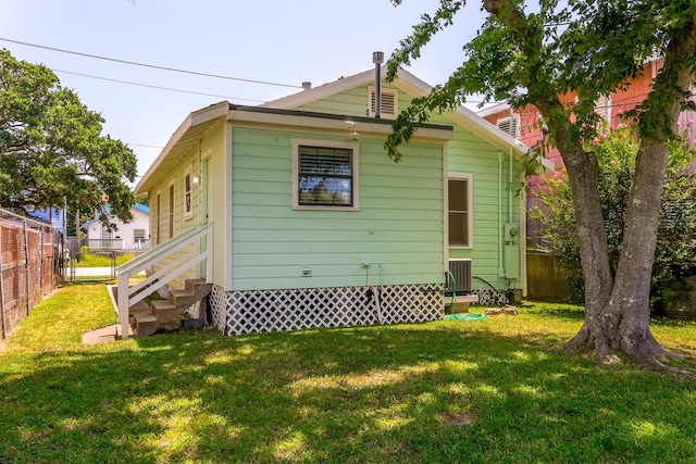 1523 22nd St, Galveston, TX 77550 - back of house featuring central air condition unit and entry steps