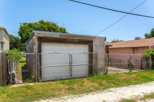 1523 22nd St, Galveston, TX 77550 - detached garage featuring a gate