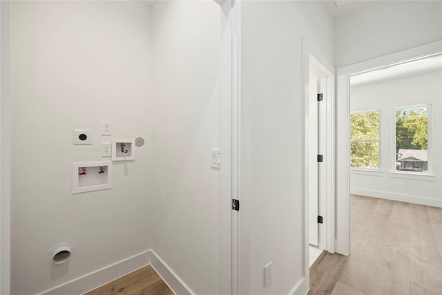 8618 Lee Otis St A-B, Unit A-B Houston, TX 77051 - washroom featuring hookup for an electric dryer, light wood-type flooring, baseboards, and hookup for a washing machine