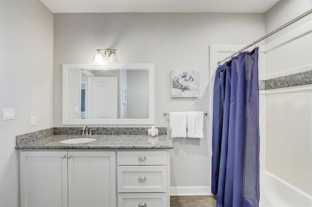 4114 Defender Ln, Galveston, TX 77554 - full bathroom featuring vanity, baseboards, and shower / bath combo