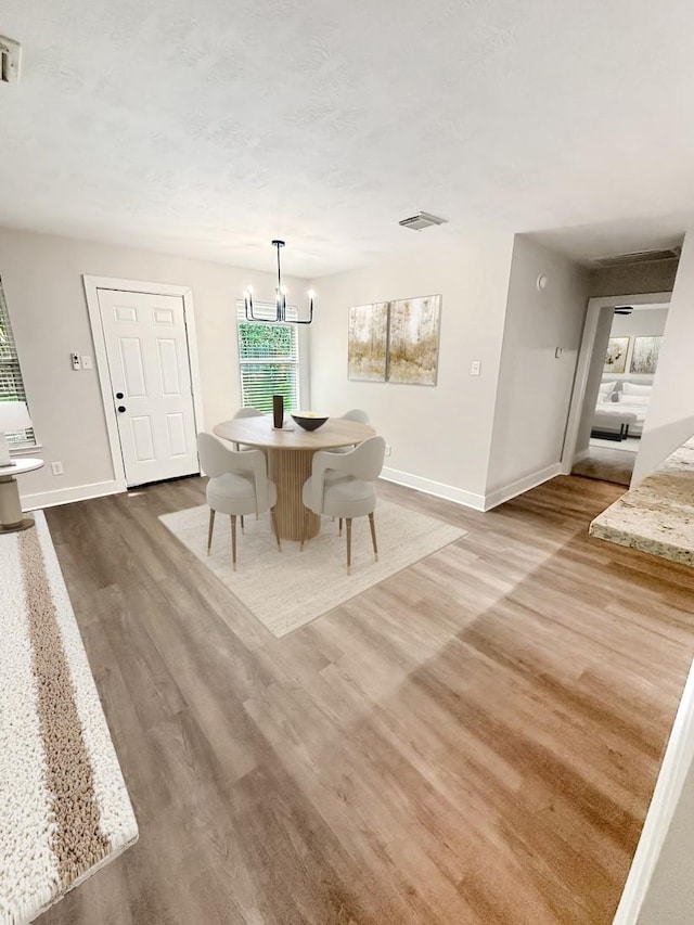 17422 Typhoon Way, Crosby, TX 77532 - dining space featuring baseboards, dark wood-style floors, and a chandelier