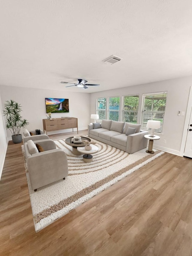 17422 Typhoon Way, Crosby, TX 77532 - living room featuring wood finished floors, baseboards, and plenty of natural light
