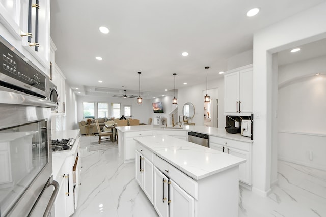 29007 Dryander Forest Ct, Katy, TX 77494 - kitchen featuring a peninsula, appliances with stainless steel finishes, open floor plan, recessed lighting, and light marble finish floors