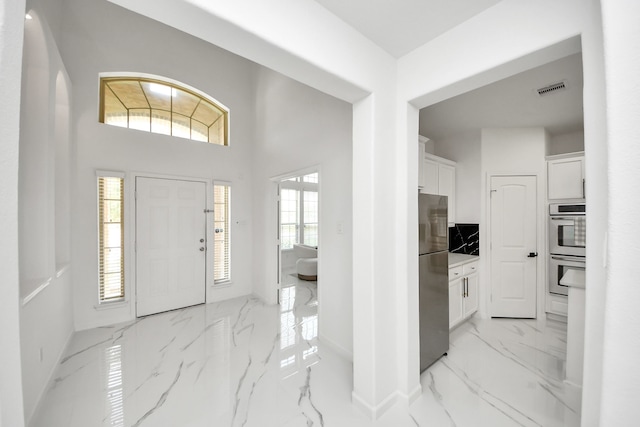 29007 Dryander Forest Ct, Katy, TX 77494 - foyer featuring light marble finish flooring and baseboards
