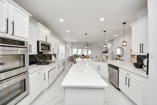 29007 Dryander Forest Ct, Katy, TX 77494 - kitchen featuring stainless steel appliances, a sink, a peninsula, open floor plan, and recessed lighting