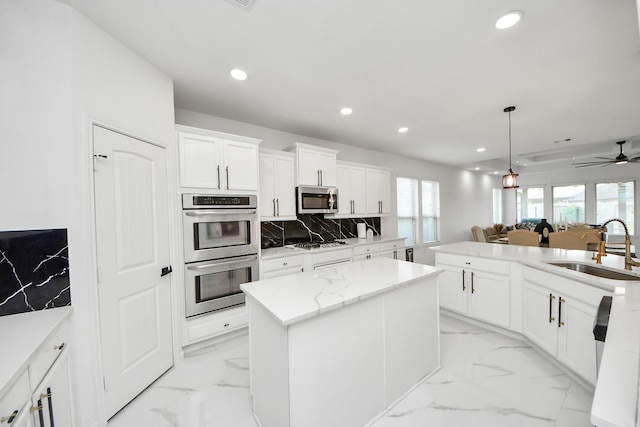 29007 Dryander Forest Ct, Katy, TX 77494 - kitchen with stainless steel appliances, a sink, a center island, recessed lighting, and light marble finish flooring