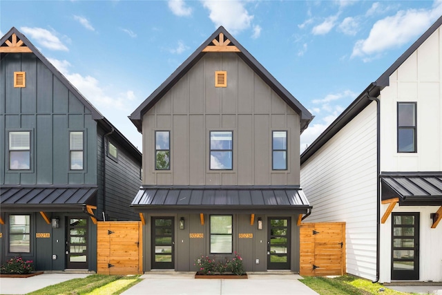 8023 Cora St, Houston, TX 77088 - view of front facade featuring a gate, board and batten siding, and a standing seam roof