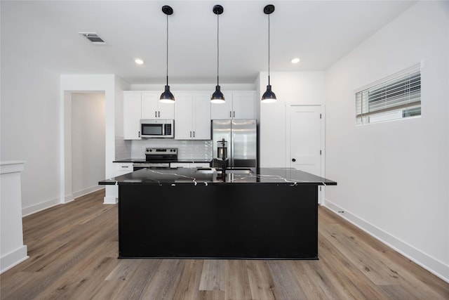 8019 Cora St, Houston, TX 77088 - kitchen with appliances with stainless steel finishes, dark countertops, wood finished floors, decorative backsplash, and recessed lighting