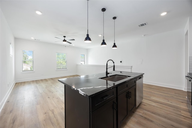 8019 Cora St, Houston, TX 77088 - kitchen featuring a sink, stainless steel dishwasher, light wood finished floors, dark countertops, and recessed lighting
