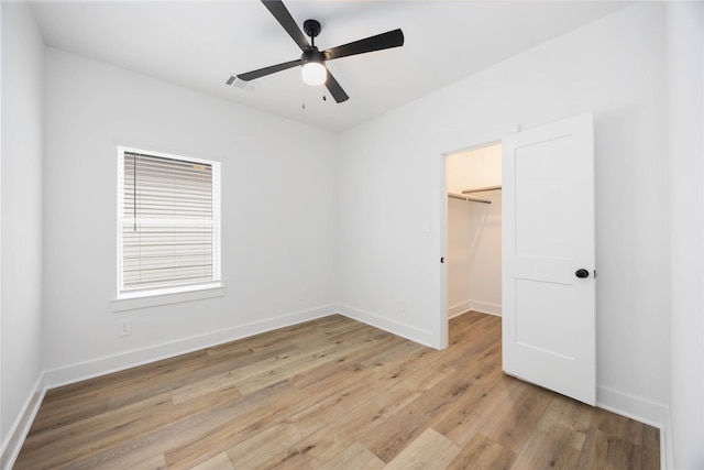 8019 Cora St, Houston, TX 77088 - unfurnished bedroom with a walk in closet, light wood finished floors, baseboards, and a closet