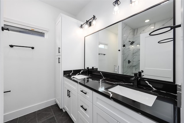 8019 Cora St, Houston, TX 77088 - full bath with marble look tiles, double vanity, a marble finish shower, and baseboards