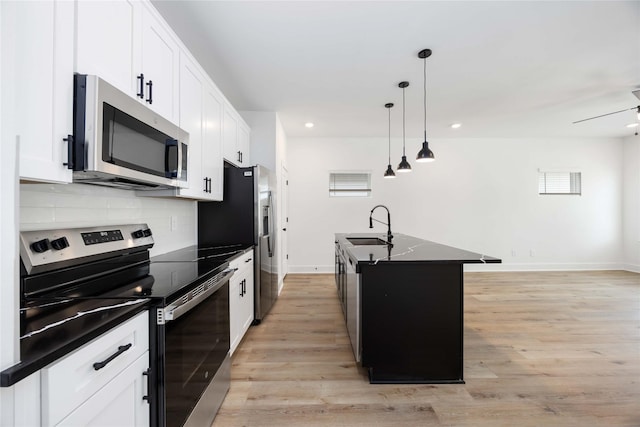 8019 Cora St, Houston, TX 77088 - kitchen featuring appliances with stainless steel finishes, dark countertops, tasteful backsplash, white cabinets, and recessed lighting