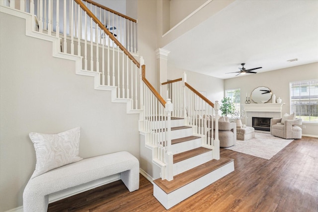 4643 Forest Home Dr, Missouri City, TX 77459 - stairs with ceiling fan, wood finished floors, a fireplace, and baseboards