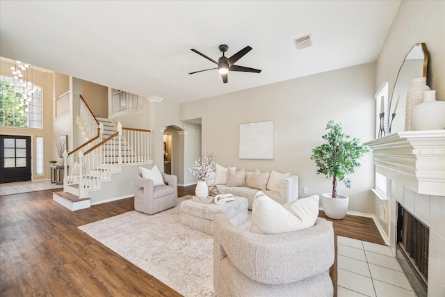 4643 Forest Home Dr, Missouri City, TX 77459 - living area featuring stairway, a tile fireplace, ceiling fan, and plenty of natural light