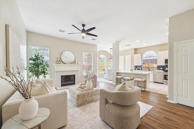 4643 Forest Home Dr, Missouri City, TX 77459 - living area featuring plenty of natural light, light wood-style flooring, ceiling fan, decorative columns, and recessed lighting