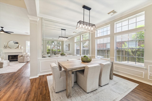 4643 Forest Home Dr, Missouri City, TX 77459 - dining room with ornamental molding, wood finished floors, a ceiling fan, and a tiled fireplace