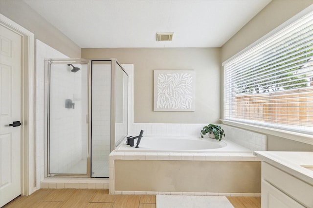 4643 Forest Home Dr, Missouri City, TX 77459 - full bath with a garden tub, a stall shower, vanity, and wood finished floors