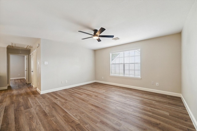 4643 Forest Home Dr, Missouri City, TX 77459 - empty room with attic access, a ceiling fan, wood finished floors, and baseboards