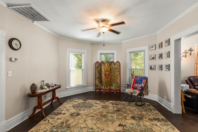 404 E Alabama St, Wharton, TX 77488 - living area with a ceiling fan, healthy amount of natural light, baseboards, crown molding, and a textured ceiling