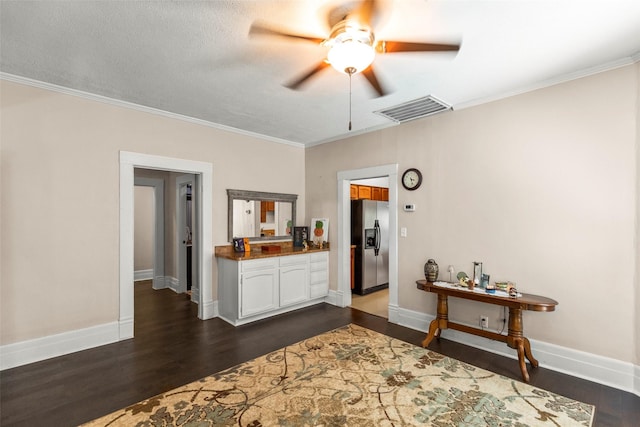 404 E Alabama St, Wharton, TX 77488 - bedroom featuring stainless steel fridge with ice dispenser, dark wood-type flooring, crown molding, and baseboards