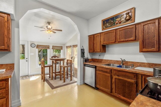 404 E Alabama St, Wharton, TX 77488 - kitchen with dishwasher, a sink, lofted ceiling, a ceiling fan, and brown cabinets