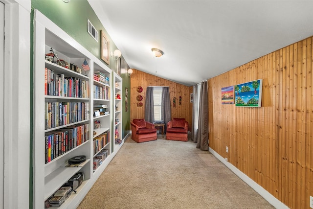 404 E Alabama St, Wharton, TX 77488 - living area with lofted ceiling, carpet flooring, and wooden walls