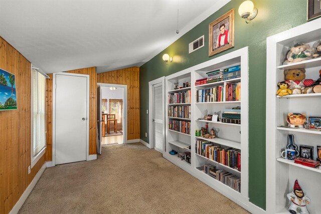 404 E Alabama St, Wharton, TX 77488 - corridor featuring vaulted ceiling, wood walls, and carpet floors