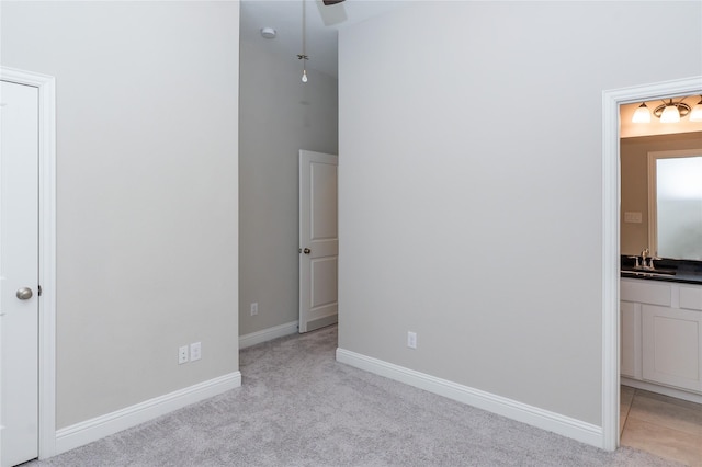 8408 Oak Leaf Point Dr, Houston, TX 77055 - unfurnished bedroom with light colored carpet, a sink, ensuite bathroom, and baseboards