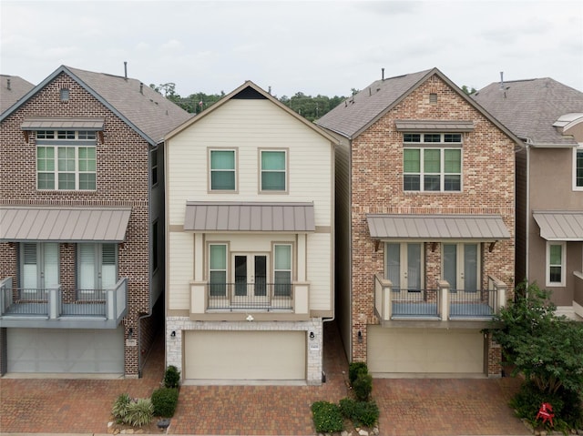8408 Oak Leaf Point Dr, Houston, TX 77055 - view of property featuring a garage, decorative driveway, french doors, and brick siding