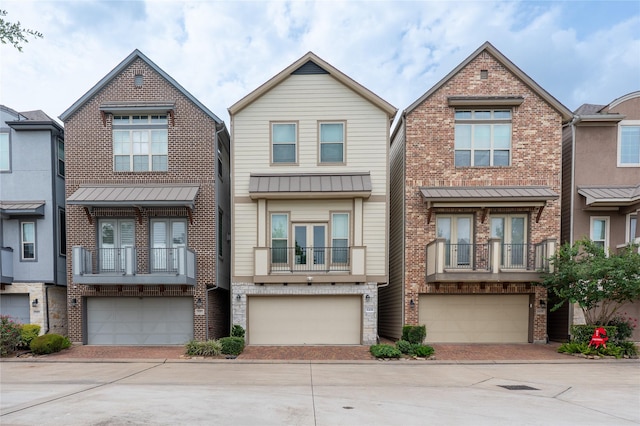 8408 Oak Leaf Point Dr, Houston, TX 77055 - view of property featuring a standing seam roof, decorative driveway, an attached garage, and metal roof