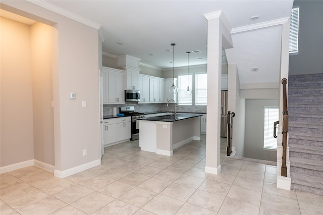 8408 Oak Leaf Point Dr, Houston, TX 77055 - kitchen featuring stainless steel appliances, dark countertops, a center island with sink, tasteful backsplash, and light tile patterned flooring