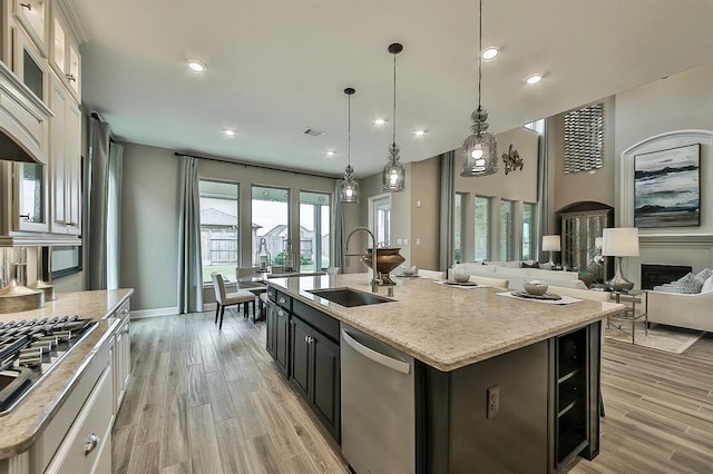 29506 Highland Manor Ct, Katy, TX 77494 - kitchen featuring a sink, appliances with stainless steel finishes, a kitchen island with sink, light wood-type flooring, and recessed lighting
