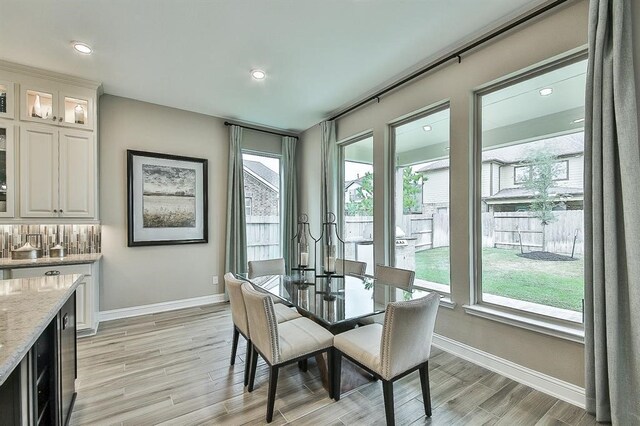 29506 Highland Manor Ct, Katy, TX 77494 - dining room with baseboards, light wood-type flooring, plenty of natural light, and recessed lighting