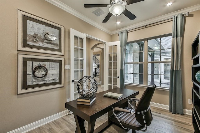 29506 Highland Manor Ct, Katy, TX 77494 - office area featuring crown molding, arched walkways, light wood-style flooring, and baseboards