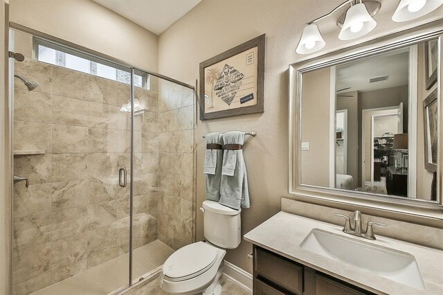 29506 Highland Manor Ct, Katy, TX 77494 - bathroom featuring a stall shower, toilet, vanity, and baseboards