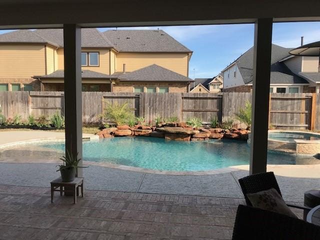 29506 Highland Manor Ct, Katy, TX 77494 - view of swimming pool featuring a fenced backyard, a residential view, a patio area, and a pool with connected hot tub