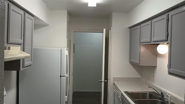 9797 Leawood Blvd Unit 408, Houston, TX 77099 - kitchen with white appliances, a sink, gray cabinets, and light countertops