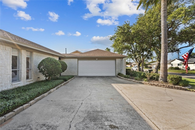 2505 Gerol Dr, Galveston, TX 77551 - view of side of property featuring brick siding, driveway, and an attached garage