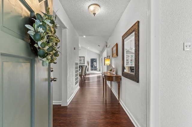 2505 Gerol Dr, Galveston, TX 77551 - hall with vaulted ceiling, a textured wall, wood finished floors, a textured ceiling, and baseboards