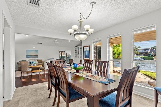 2505 Gerol Dr, Galveston, TX 77551 - dining space featuring a chandelier, a textured ceiling, ceiling fan, and baseboards