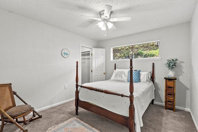 2505 Gerol Dr, Galveston, TX 77551 - carpeted bedroom featuring baseboards, a textured ceiling, a ceiling fan, and a spacious closet