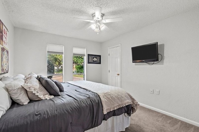2505 Gerol Dr, Galveston, TX 77551 - bedroom featuring carpet, baseboards, a ceiling fan, and a textured ceiling