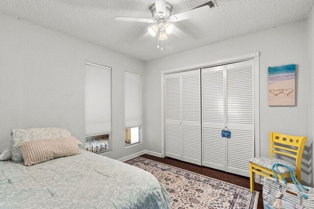 2505 Gerol Dr, Galveston, TX 77551 - bedroom with wood finished floors, a textured ceiling, a closet, ceiling fan, and baseboards