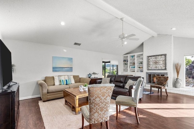 2505 Gerol Dr, Galveston, TX 77551 - living room featuring ceiling fan, wood finished floors, a textured ceiling, baseboards, and a fireplace