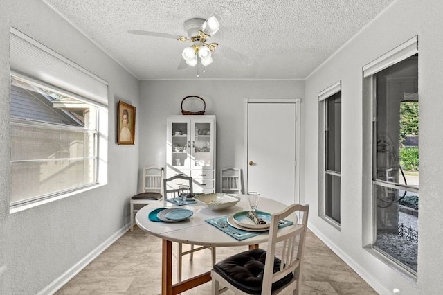 2505 Gerol Dr, Galveston, TX 77551 - dining space featuring plenty of natural light, a textured ceiling, ceiling fan, and baseboards