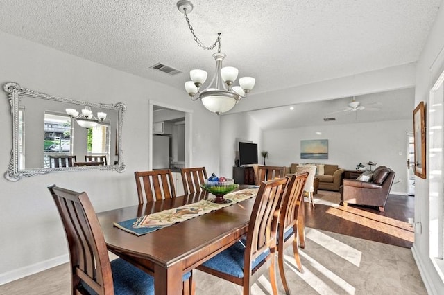2505 Gerol Dr, Galveston, TX 77551 - dining room with a chandelier, a textured ceiling, a ceiling fan, and baseboards