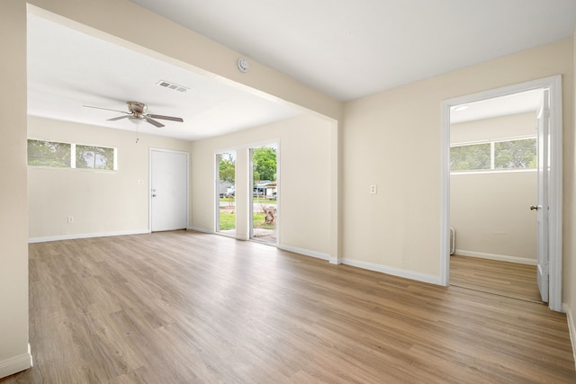 4726 Angleton St, Houston, TX 77033 - spare room featuring a ceiling fan, light wood finished floors, and baseboards