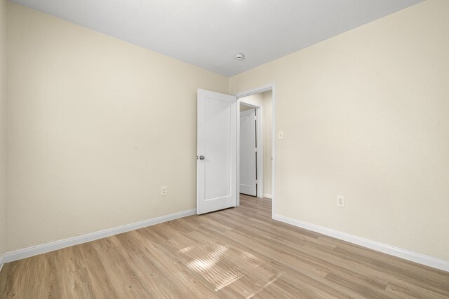 4726 Angleton St, Houston, TX 77033 - empty room with baseboards, light wood-style floors, and a smoke detector